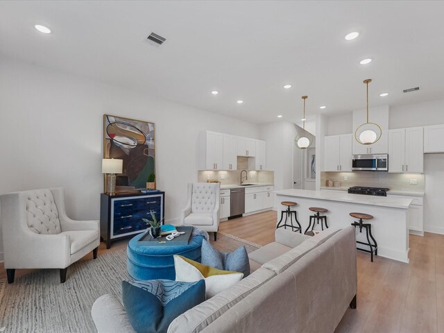 5016 Golden Forest Dr, Houston, TX 77091 - living room with light wood-style flooring and recessed lighting