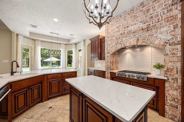 24914 Misty Heath Ln, Katy, TX 77494 - kitchen featuring appliances with stainless steel finishes, a textured ceiling, backsplash, a sink, and a raised ceiling