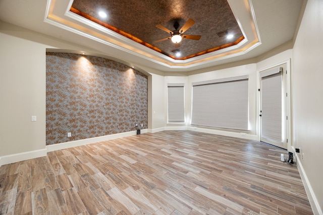 24914 Misty Heath Ln, Katy, TX 77494 - spare room featuring a tray ceiling, a ceiling fan, wallpapered walls, crown molding, and wood finished floors
