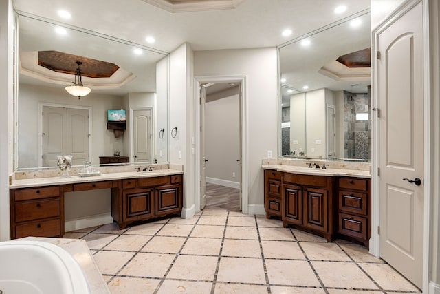 24914 Misty Heath Ln, Katy, TX 77494 - full bath featuring a tray ceiling, crown molding, two vanities, baseboards, and recessed lighting
