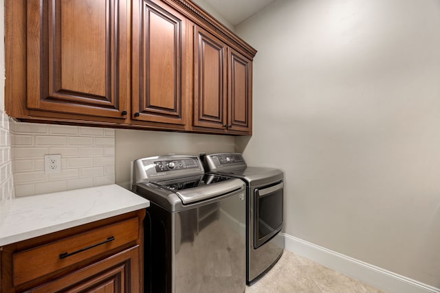 24914 Misty Heath Ln, Katy, TX 77494 - laundry area featuring cabinet space, washing machine and dryer, baseboards, and tile patterned flooring