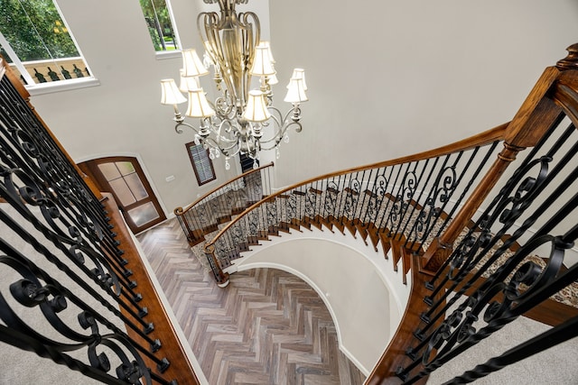 24914 Misty Heath Ln, Katy, TX 77494 - stairway with a chandelier, a towering ceiling, and arched walkways
