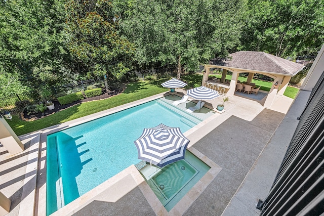 24914 Misty Heath Ln, Katy, TX 77494 - view of pool with a gazebo, a pool with connected hot tub, a patio, and view of wooded area
