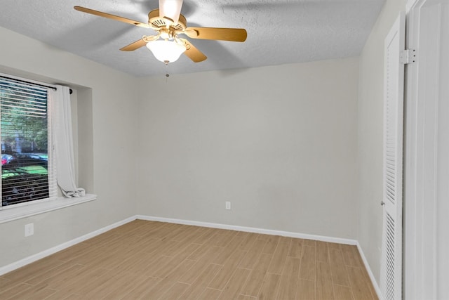 6606 Chancellor Dr, Spring, TX 77379 - unfurnished bedroom featuring baseboards, light wood-style floors, a textured ceiling, and a ceiling fan