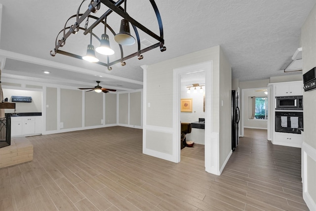6606 Chancellor Dr, Spring, TX 77379 - unfurnished living room with light wood-style floors, a ceiling fan, baseboards, and a chandelier