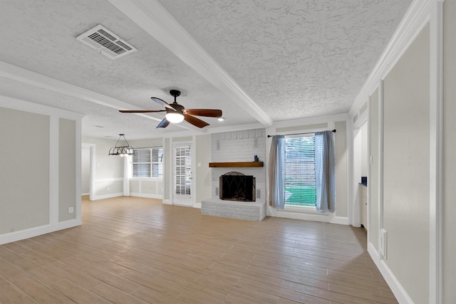 6606 Chancellor Dr, Spring, TX 77379 - unfurnished living room featuring a brick fireplace, a textured ceiling, light wood-style flooring, baseboards, and a ceiling fan
