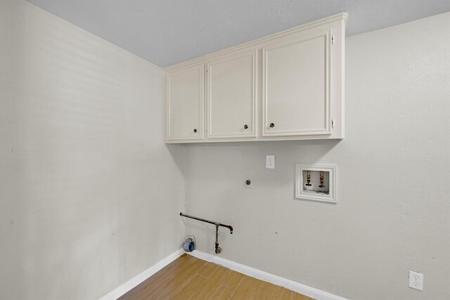 6606 Chancellor Dr, Spring, TX 77379 - washroom featuring washer hookup, hookup for an electric dryer, baseboards, hookup for a gas dryer, and light wood-style floors