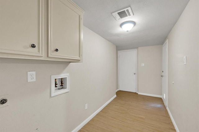 6606 Chancellor Dr, Spring, TX 77379 - laundry room featuring cabinet space, light wood-style flooring, hookup for a washing machine, baseboards, and electric dryer hookup