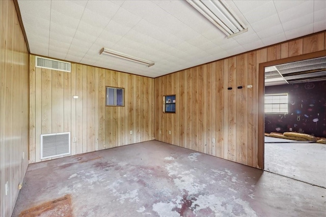 2432 Westpine Rd, Beaumont, TX 77713 - empty room featuring concrete flooring and wooden walls