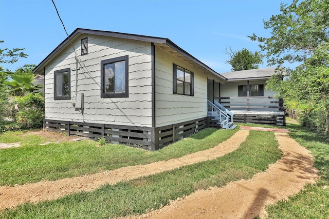 4909 Falls St, Houston, TX 77026 - view of home's exterior featuring a lawn
