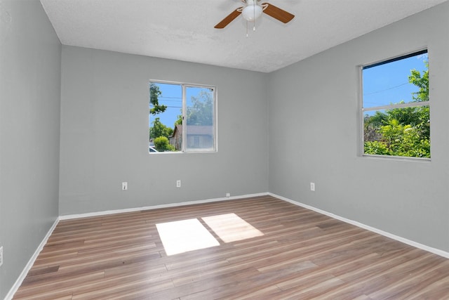 4909 Falls St, Houston, TX 77026 - unfurnished room featuring light wood-style flooring, ceiling fan, a textured ceiling, and baseboards