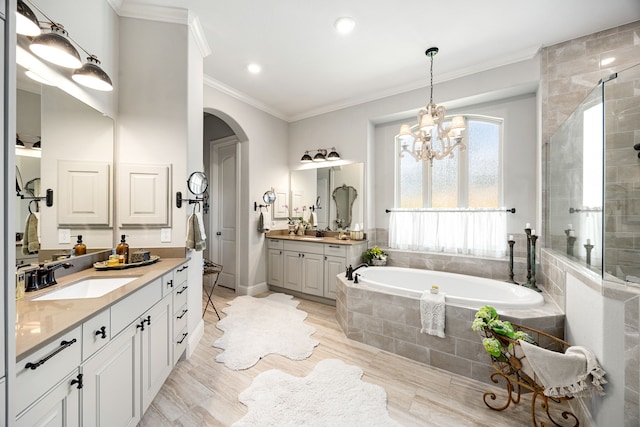1003 Angel Forest Ct, Pinehurst, TX 77362 - full bathroom with a bath, a stall shower, two vanities, ornamental molding, and a chandelier