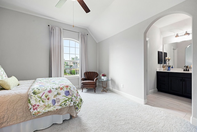 1003 Angel Forest Ct, Pinehurst, TX 77362 - bedroom with arched walkways, lofted ceiling, connected bathroom, light colored carpet, and ceiling fan