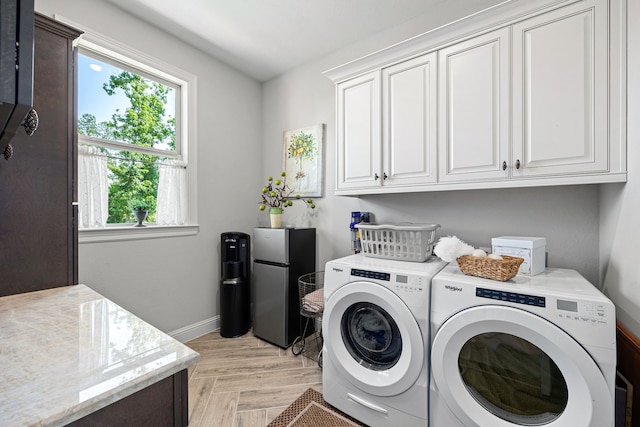 1003 Angel Forest Ct, Pinehurst, TX 77362 - laundry area featuring cabinet space and separate washer and dryer