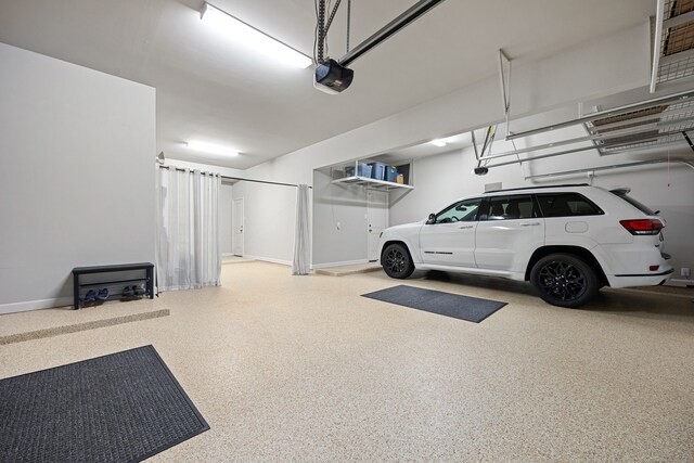 1003 Angel Forest Ct, Pinehurst, TX 77362 - garage featuring a garage door opener and baseboards
