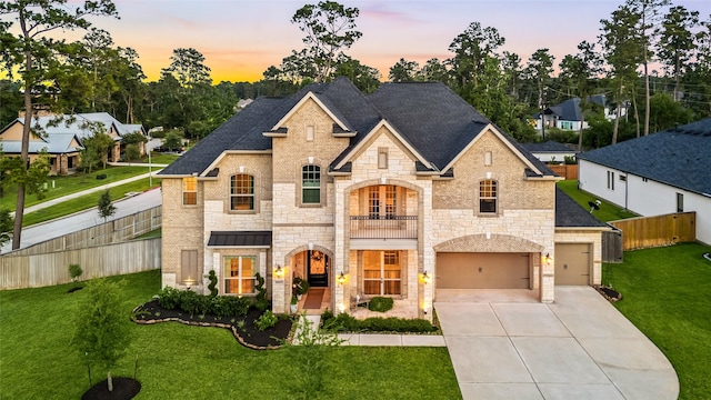 1003 Angel Forest Ct, Pinehurst, TX 77362 - french country inspired facade featuring a balcony, stone siding, concrete driveway, and roof with shingles