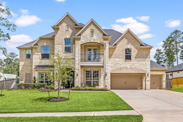 1003 Angel Forest Ct, Pinehurst, TX 77362 - french country home with driveway, stone siding, a balcony, and brick siding