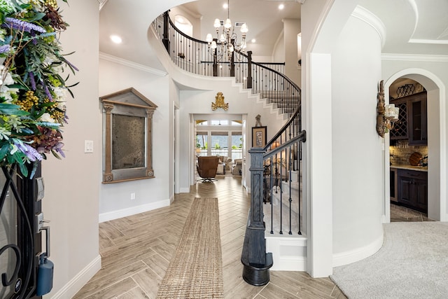 1003 Angel Forest Ct, Pinehurst, TX 77362 - foyer featuring crown molding, stairs, a chandelier, recessed lighting, and a high ceiling