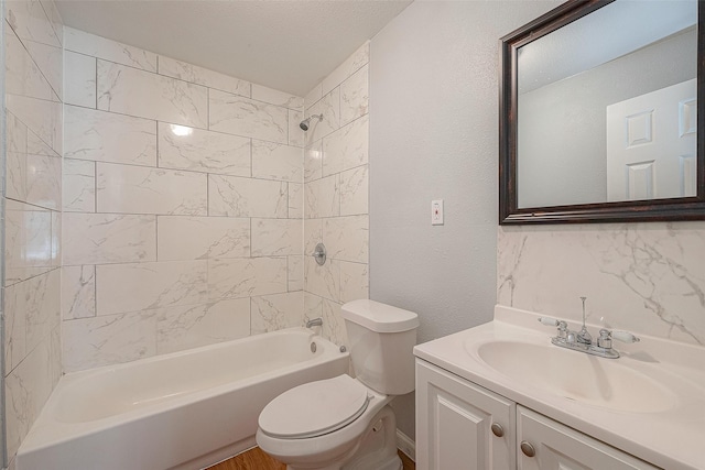 5619 Willow Glen Dr, Houston, TX 77033 - full bath with toilet, vanity, shower / bathtub combination, and a textured wall