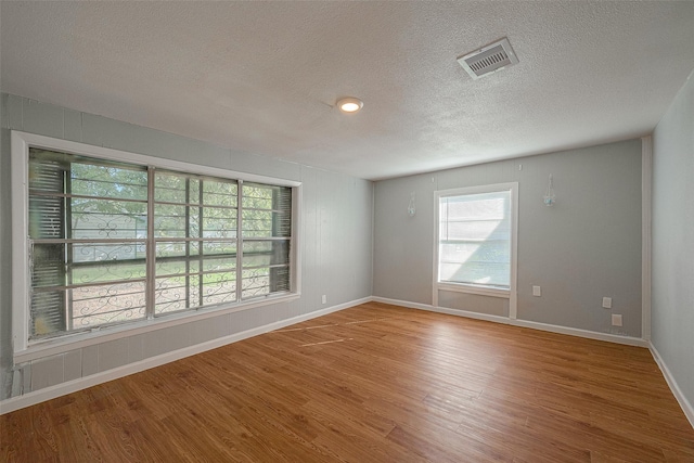 5619 Willow Glen Dr, Houston, TX 77033 - spare room with a textured ceiling, wood finished floors, and baseboards
