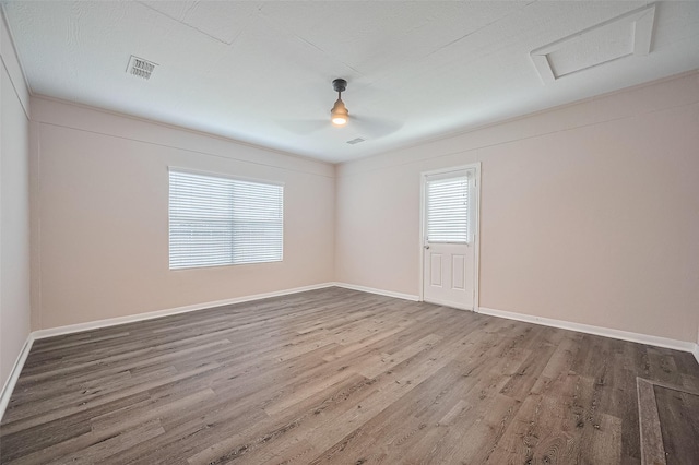 28861 Llano River Loop, Spring, TX 77386 - spare room featuring wood finished floors, baseboards, ceiling fan, and attic access