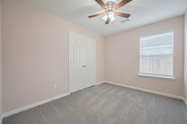 28861 Llano River Loop, Spring, TX 77386 - unfurnished bedroom featuring carpet, baseboards, a closet, and ceiling fan