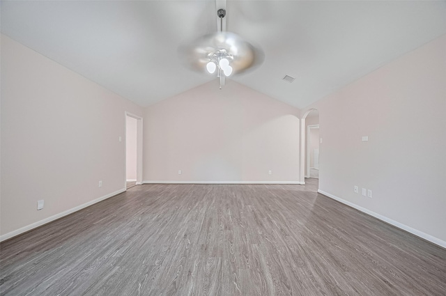 28861 Llano River Loop, Spring, TX 77386 - unfurnished living room with a ceiling fan, wood finished floors, lofted ceiling, arched walkways, and baseboards