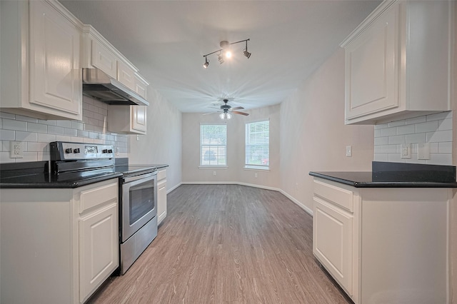 28861 Llano River Loop, Spring, TX 77386 - kitchen with stainless steel range with electric cooktop, under cabinet range hood, ceiling fan, light wood-style floors, and dark countertops