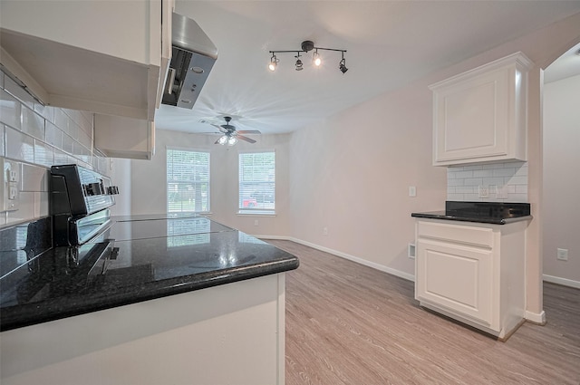 28861 Llano River Loop, Spring, TX 77386 - kitchen featuring backsplash, ceiling fan, white cabinets, light wood-type flooring, and baseboards