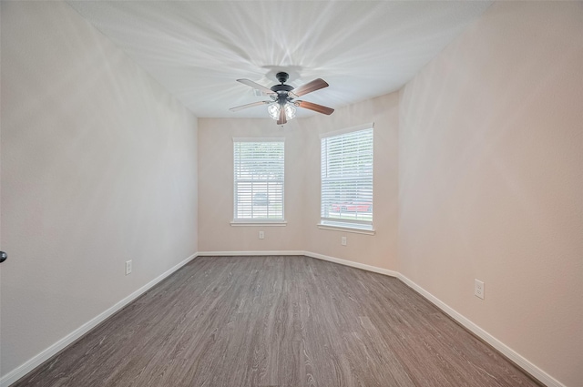 28861 Llano River Loop, Spring, TX 77386 - unfurnished room with dark wood-type flooring, baseboards, and ceiling fan