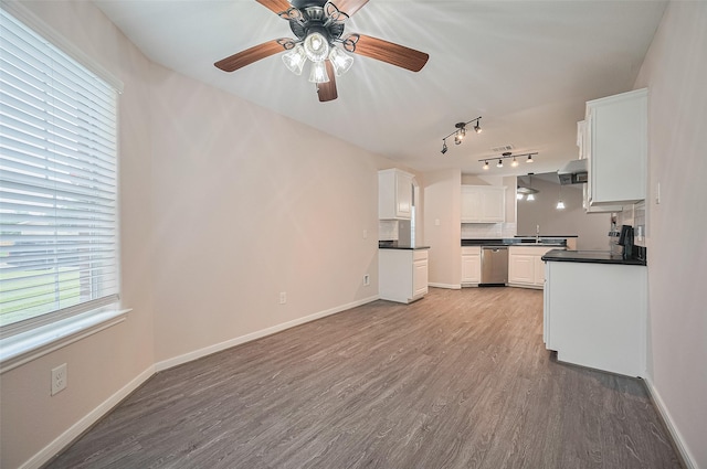 28861 Llano River Loop, Spring, TX 77386 - unfurnished living room featuring wood finished floors, rail lighting, and baseboards
