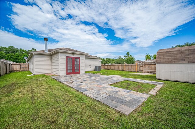 28861 Llano River Loop, Spring, TX 77386 - view of yard with french doors, a patio area, and central AC