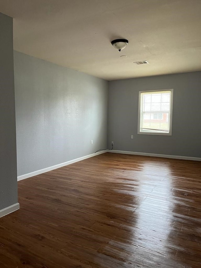 6058 Glenhurst Dr, Houston, TX 77033 - empty room featuring dark wood finished floors and baseboards