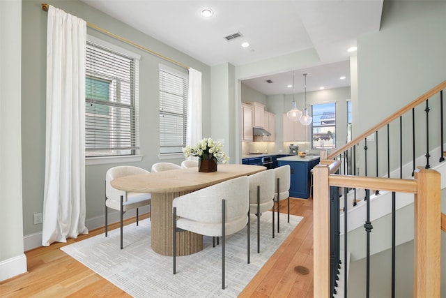 5421 Larkin St, Houston, TX 77007 - dining area with light wood finished floors, stairway, baseboards, and recessed lighting