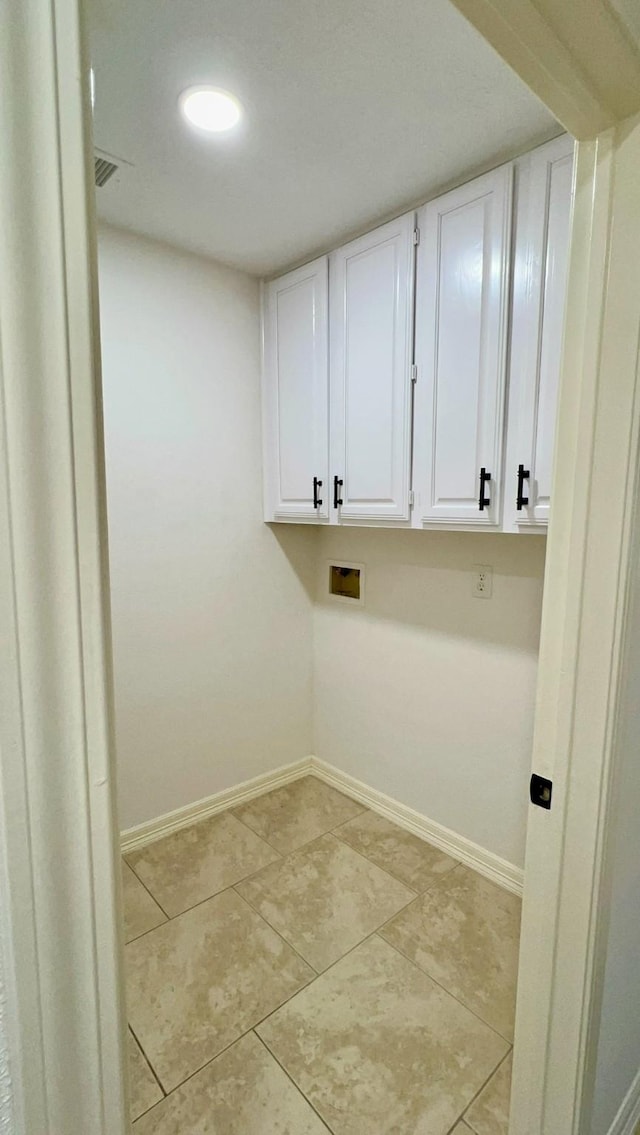 9827 Westminster Dr, Humble, TX 77338 - washroom with hookup for a washing machine, baseboards, cabinet space, and light tile patterned floors