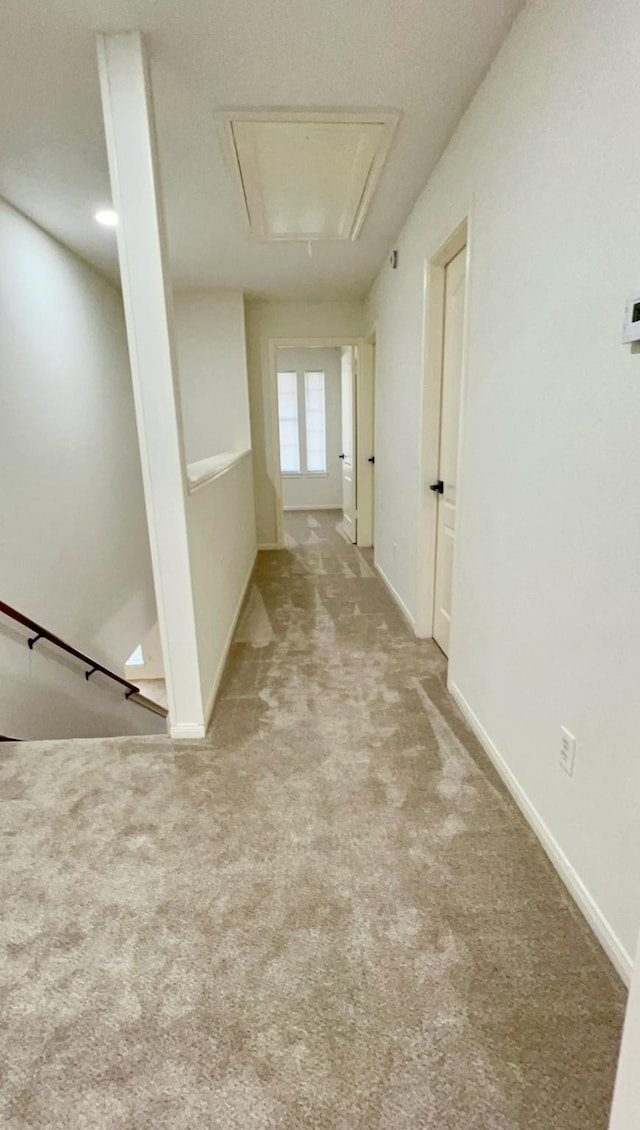 9827 Westminster Dr, Humble, TX 77338 - hallway with attic access, carpet floors, baseboards, and an upstairs landing