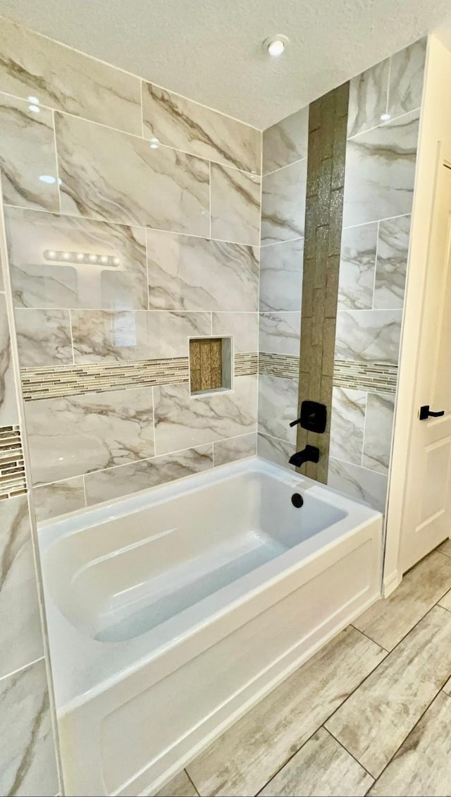 9827 Westminster Dr, Humble, TX 77338 - bathroom with a tub to relax in and a textured ceiling