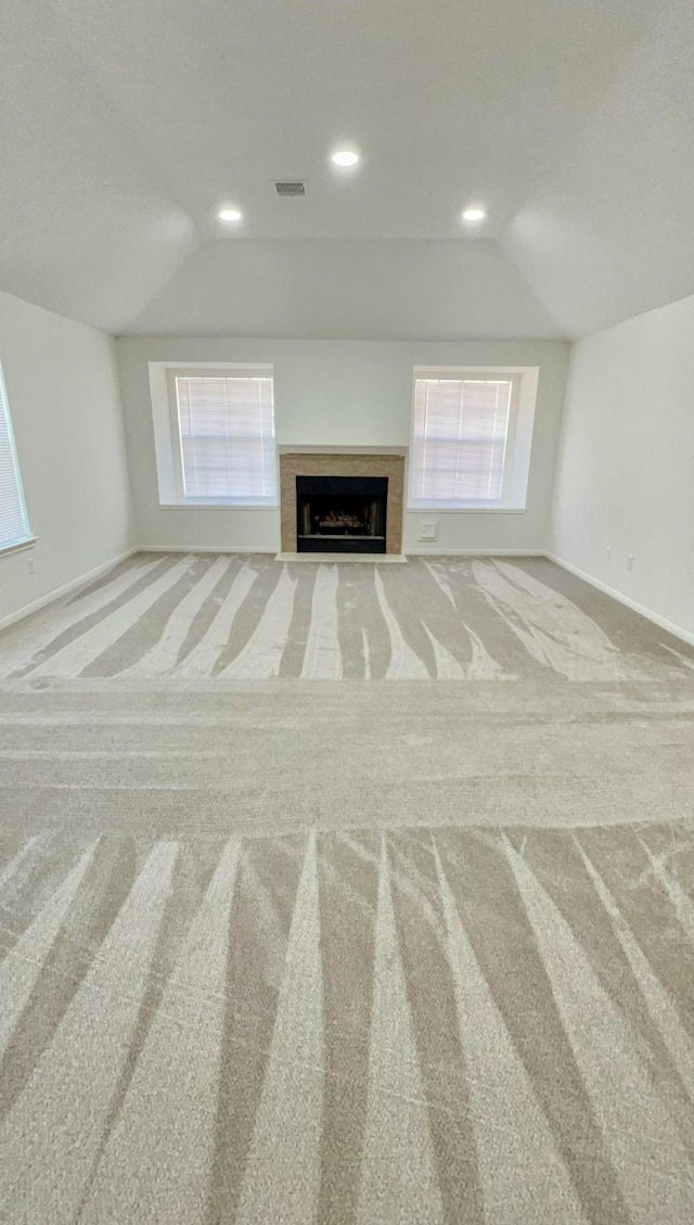 9827 Westminster Dr, Humble, TX 77338 - unfurnished living room with lofted ceiling, carpet flooring, baseboards, a fireplace with flush hearth, and recessed lighting