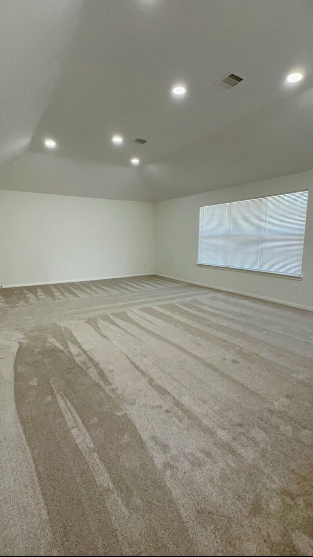 9827 Westminster Dr, Humble, TX 77338 - spare room with lofted ceiling, carpet, and recessed lighting