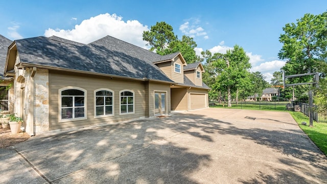 28622 Champions Dr, Magnolia, TX 77355 - view of side of property with driveway, stone siding, and roof with shingles