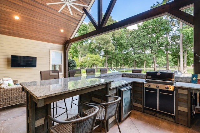 28622 Champions Dr, Magnolia, TX 77355 - view of patio with exterior kitchen and view of wooded area