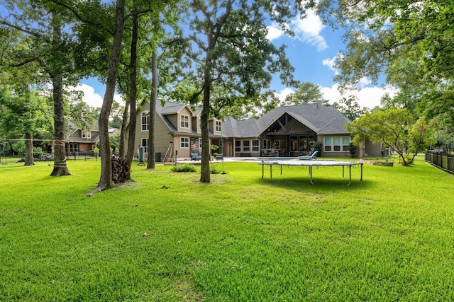 28622 Champions Dr, Magnolia, TX 77355 - view of yard featuring a trampoline and a sunroom