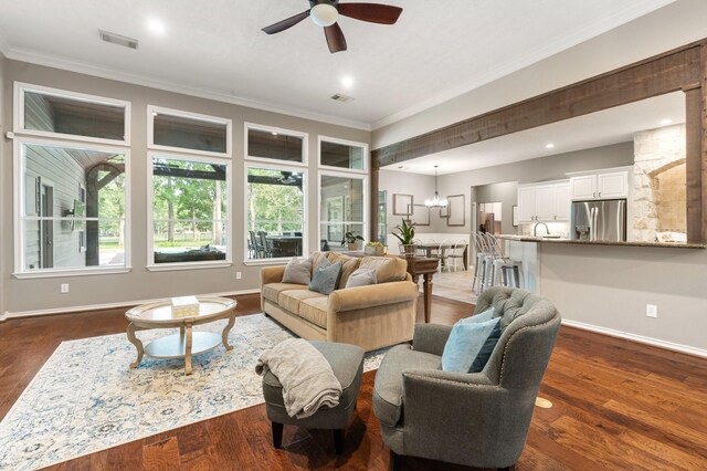 28622 Champions Dr, Magnolia, TX 77355 - living area with ornamental molding, ceiling fan, dark wood finished floors, recessed lighting, and a chandelier