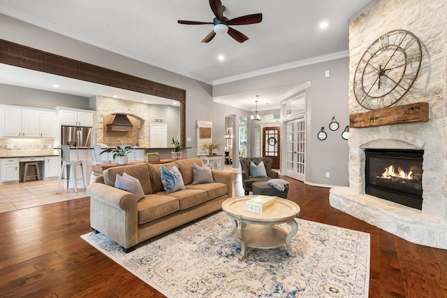 28622 Champions Dr, Magnolia, TX 77355 - living area featuring ceiling fan, crown molding, hardwood / wood-style flooring, a fireplace, and recessed lighting
