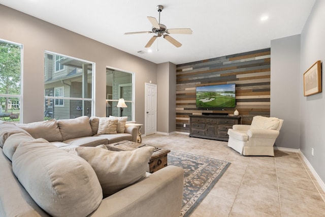 28622 Champions Dr, Magnolia, TX 77355 - living room with an accent wall, wooden walls, ceiling fan, recessed lighting, and tile patterned flooring