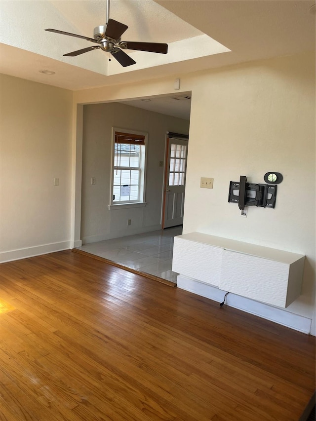 1100 Clayton Ln, Austin, TX 78723 - empty room with ceiling fan, wood finished floors, and baseboards