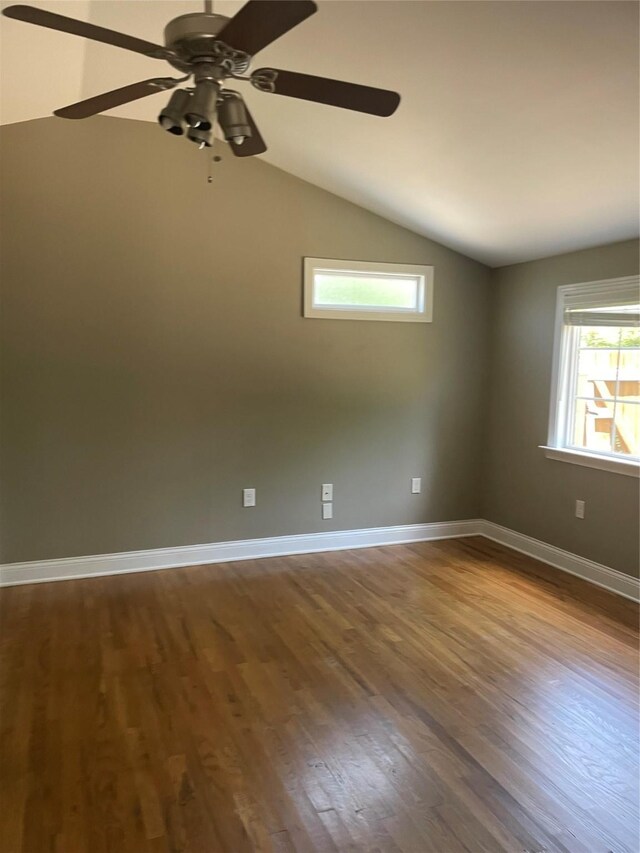 1100 Clayton Ln, Austin, TX 78723 - spare room featuring dark wood-style floors, vaulted ceiling, a ceiling fan, and baseboards