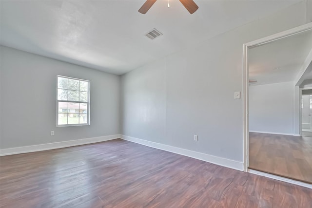 3918 Tavenor Ln, Houston, TX 77047 - spare room featuring dark wood-style floors, a ceiling fan, and baseboards