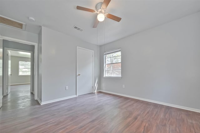 3918 Tavenor Ln, Houston, TX 77047 - unfurnished bedroom featuring multiple windows, wood finished floors, and baseboards