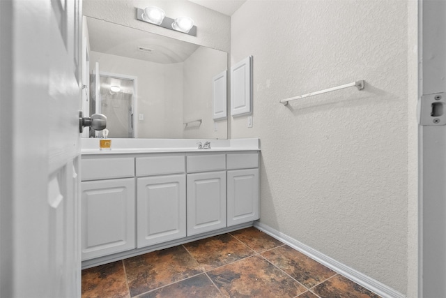 19034 Ashford Square St, Tomball, TX 77375 - bathroom featuring vanity, a textured wall, and baseboards